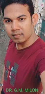 Portrait in burgundy shirt outdoors.