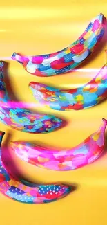 Vibrant painted bananas on a yellow background, perfect for colorful wallpapers.