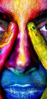 Vibrant painted face with colorful hands and expressive eyes.