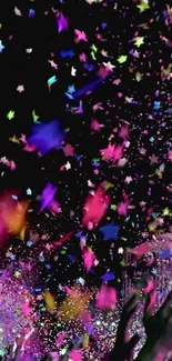 Colorful confetti stars burst over a dark background at a party.