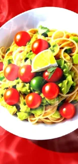 Pasta with avocado, tomatoes on red background.