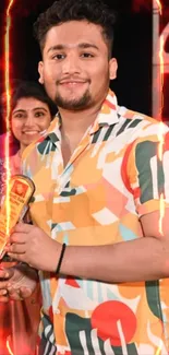 Person in a vibrant, colorful patterned shirt holding a trophy.