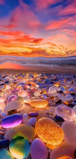 Colorful pebbles on a beach at sunset with vibrant sky.