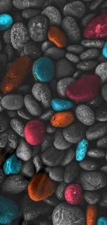 Vibrant pebbles resting on a gray surface with colorful highlights.