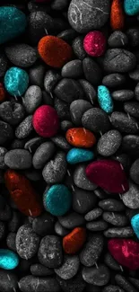 Vibrant, colorful stones on a gray pebbles background.