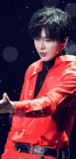 Performer in a vibrant red suit on stage.