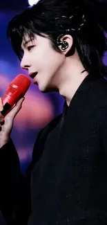 Performer with red microphone on stage, vibrant and dynamic.