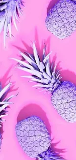 Pink background with purple pineapples creating a vibrant phone wallpaper.