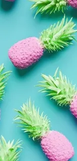 Colorful pink and green pineapples on aqua background.