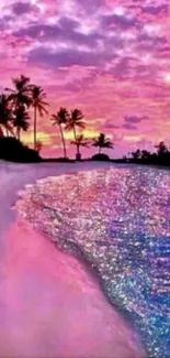 Vibrant pink beach sunset with palm trees and shimmering ocean waves.