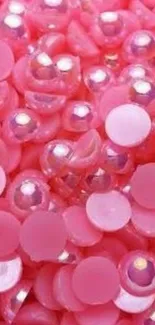 Vibrant pink beads with glossy textures in a playful pattern.