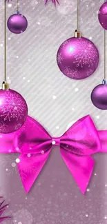 Vibrant pink wallpaper with Christmas ornaments and a festive bow.