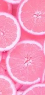 Vibrant pink grapefruit slices wallpaper.