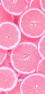 Bright pink grapefruit slices wallpaper with vibrant citrus colors.