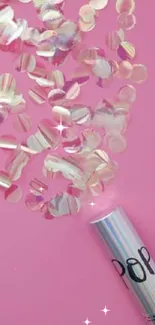 Colorful confetti popper on a pink background exuding festivity.