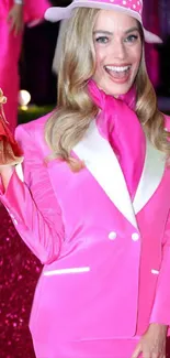 Person in vibrant pink suit, holding a small doll figure.