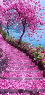 Pink petal pathway beside blue lake under cherry blossoms.