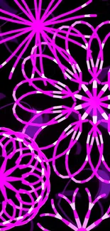 Intricate neon pink floral design on a black background.