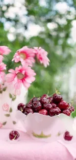 Pink flowers and cherries in a bowl, creating a vibrant summer scene.