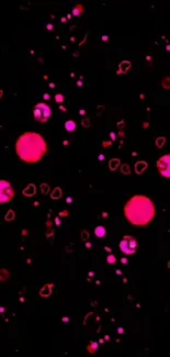 Vibrant pink dots scattered across a black background in a digital wallpaper.