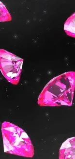 Scattered vibrant pink diamonds on black background mobile wallpaper.