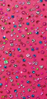 Vibrant pink wallpaper with colorful gemstones creating a sparkling pattern.