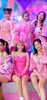 Group photo with vibrant pink outfits and colorful backdrop.