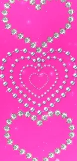 Vibrant pink mobile wallpaper with jewel-studded heart pattern.