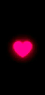 Vibrant glowing pink heart on black background.