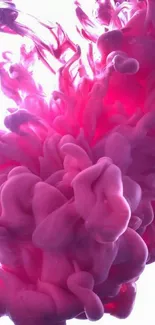 Pink ink gracefully swirling in water, forming an abstract art.