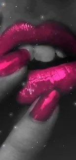 Stylish pink lips and glossy nails on a dramatic black background.