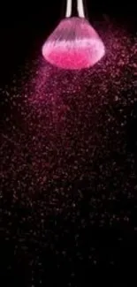 Brush with pink dust on black background mobile wallpaper.