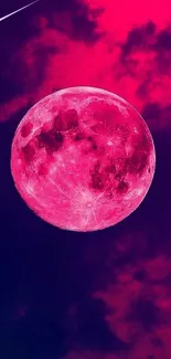 Vibrant pink moon against deep purple sky.