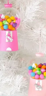 Pink gumball machine ornaments on a white tree.