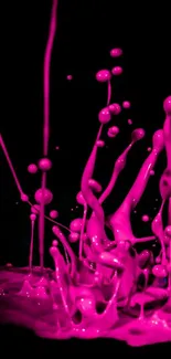 Vibrant pink and blue paint splash on dark background.