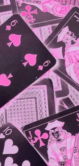 Vibrant pink playing cards on black background wallpaper.