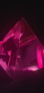 Bright pink pyramid on dark background wallpaper