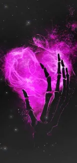 Neon pink skeleton hand holds a heart.