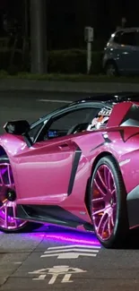 Pink supercar with neon lights on a city street at night.