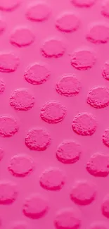 Vibrant pink wallpaper with textured dotted pattern.