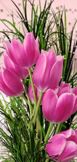 Vibrant pink tulips with green stems and leaves in a floral design.