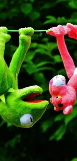 Colorful plush toys hanging on a line against green foliage.