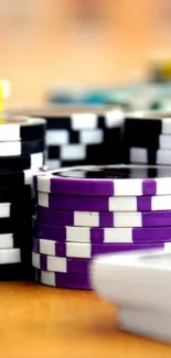 Colorful poker chip collection and cards on a table.