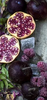 Artistic pomegranate and berry arrangement with green leaves.