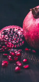 Vibrant pomegranate with seeds on dark wood.