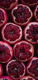 Close-up of vibrant pomegranate fruit halves with dark red seeds.