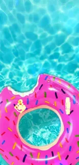 Vibrant pink donut float on turquoise water background.