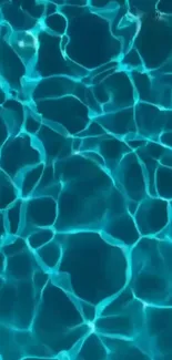 Rippling teal pool water creating vibrant patterns.