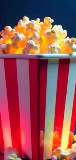 Striped popcorn bucket with glowing popcorn.