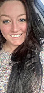 Cheerful woman inside car with long hair.